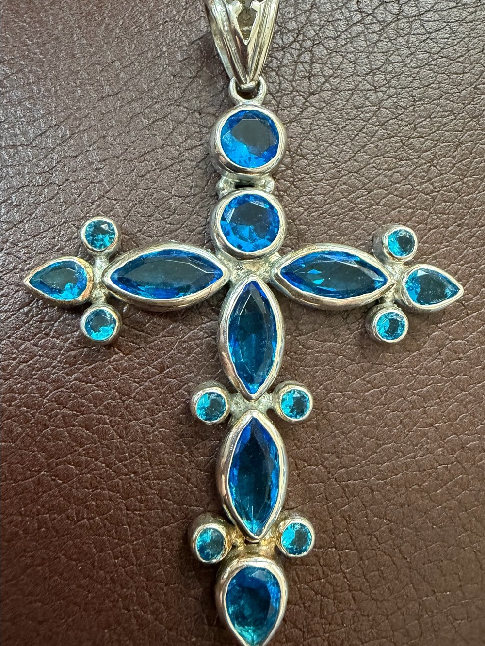 925 sterling silver cross pendant set with blue topaz accents